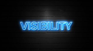 The word "Visibility" lit up in blue neon