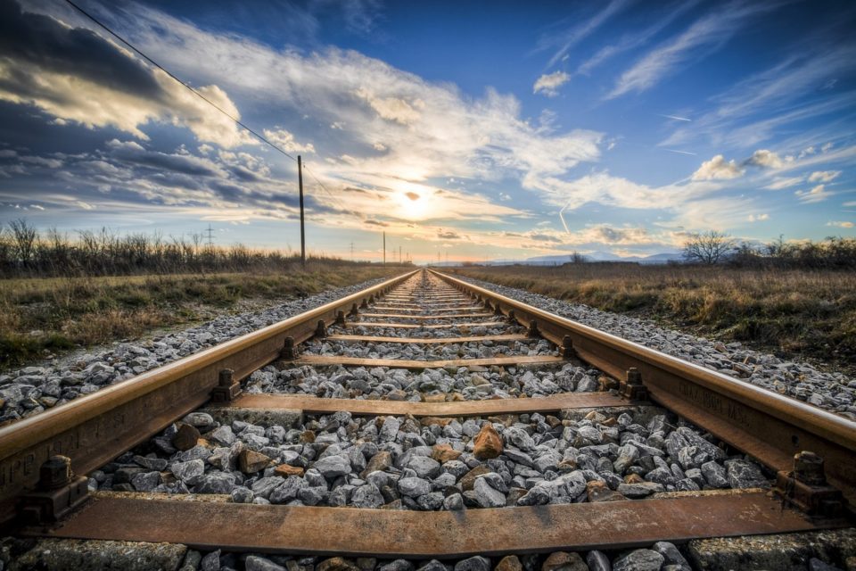 Railroad tracks heading into the sunset