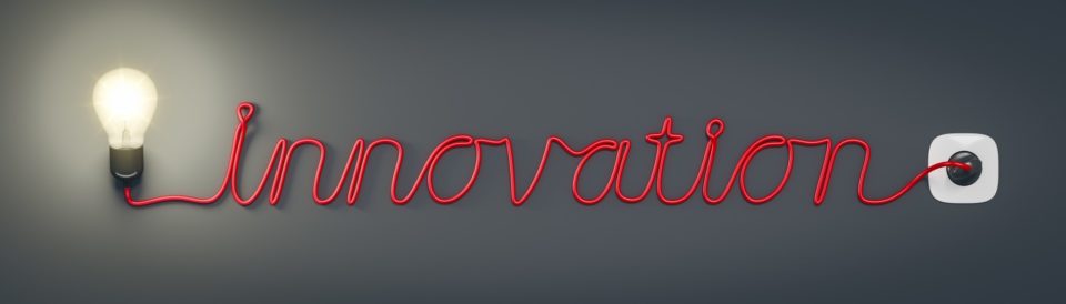 The word "Innovation" spelled with the cord from a glowing light bulb