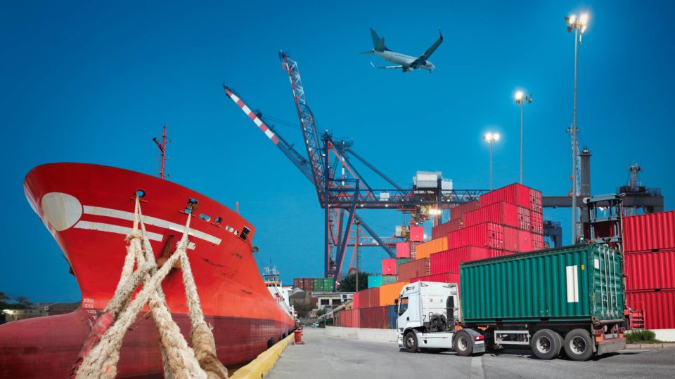 A steamship, plane and cargo truck in a dock represent various supply chain solutions