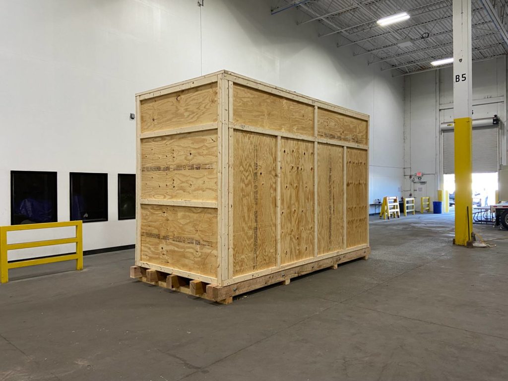 A custom crate built by Flat World in a warehouse