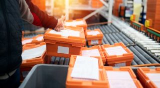 Employee sorting and shipping pharmaceutical products in a warehouse