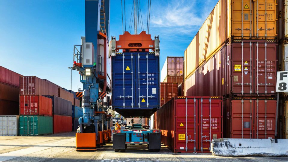 A cargo container is moved in a port, potentially avoiding detention and demurrage charges